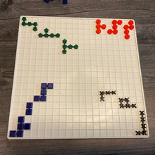 Load image into Gallery viewer, The Blockus board with the 3d printed tiles laid out on it. Each color has a different shape for tactile discrimination. The pieces are linked together into different shapes.
