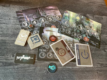 Load image into Gallery viewer, A bunch of the tokens and cards from the game laid out. all of the tokens and cards have transparent braille on them.