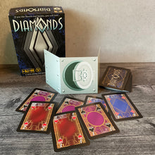 Load image into Gallery viewer, The diamond cards with transparent braille on them and the player shield