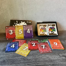 Load image into Gallery viewer, Wide shot of all the cards. The rules are in transparent braille on all of the cards.