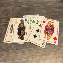 Load image into Gallery viewer, A line of cards with braille on them.