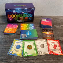 Load image into Gallery viewer, A wide shot showing 4 traits in the front with braille on them, the gene pool cards and the age cards.