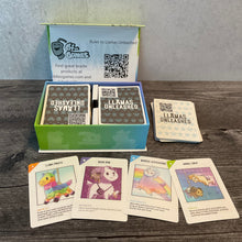 Load image into Gallery viewer, The llamas unleashed box open. A few of the cards with the transparent braille stickers are shown. The QR codes on the backs of the cards for the full text are also seen