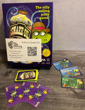 Load image into Gallery viewer, A shot of snake oil. Some customer cards and some product cards can be seen. All cards have transparent braille on them