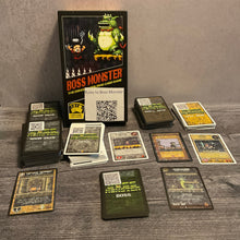 Load image into Gallery viewer, A shot showing all the various types of cards in boss monster, dungeon, hero, boss and spell cards. The cards have QR codes on the back and transparent braille on the front. Some of the cards also have braille on the back to help sort