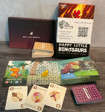 Load image into Gallery viewer, A shot showing the two types of cards, the box and the tactile player boards.