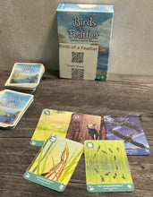 Load image into Gallery viewer, The box and the game with a bunch of cards laid out. The cards all have transparent braille on them