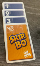Load image into Gallery viewer, A sequence of cards 1-4, with the 4 being replaced with a skip-bo card.