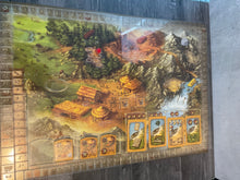 Load image into Gallery viewer, The main board with a plastic transparent overlay on it. Cards and tools are laid out in their appropriate places.