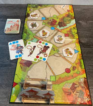 Load image into Gallery viewer, The My First Castle Panic board, laid out with monster tokens and cards on it. All have transparent braille on them
