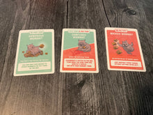 Load image into Gallery viewer, Generous wombat, confused wombat, and wicket wombat cards with transparent braille on them