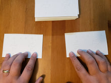 Load image into Gallery viewer, A player feeling two cards at once