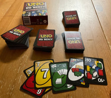Load image into Gallery viewer, A picture of Uno No Mercy laid out on the table.
