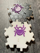 Load image into Gallery viewer, Close up shot of a black and a white beetle piece. The black piece has a texture to indicate the color and the letter B along with a tactile picture of the beetle. The sides interlock to prevent unintentional sliding of the hexagon pieces.