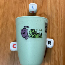 Load image into Gallery viewer, The rolling cup with the tactile LCR dice next to it.