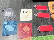 Load image into Gallery viewer, A picture of the cards laid out into three different lots. Two lots have 2 cards in them and one is empty.