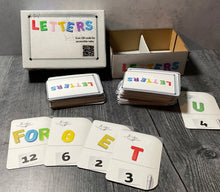 Load image into Gallery viewer, A picture of the Letters box with the letters laid out in front of it.