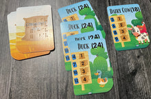 Load image into Gallery viewer, A sample stables from a player showing a player collecting ducks and dairy cows in their stables. Previously scored cards are to the left of the stables.