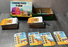 Load image into Gallery viewer, A shot of the community farm box with cards laid out in front of them. The cards have print and braille on them and show 2 hens and 2 horses.