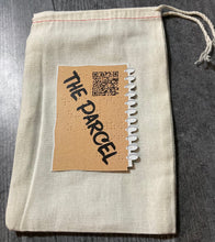 Load image into Gallery viewer, A close up showing the bag The Parcel comes in and one of the cards. The rules are presented on a QR code on the back of the card.