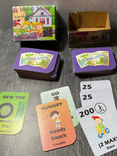 Load image into Gallery viewer, A shot of the prototype 1000 Yards box and a few of the cards laid out.