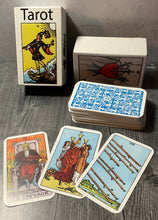 Load image into Gallery viewer, The box with a few of the cards laid out in front.