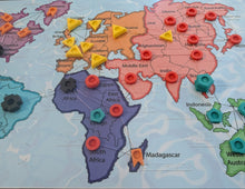 Load image into Gallery viewer, World map with colorful tactile pins on each of countries. Some of them are stacked higher than others and some of the pins are different shapes.