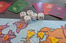 Load image into Gallery viewer, Board game setup with dice, cards, and a map of Europe on a wooden surface. The cards have braille on them and the dice are tactile.