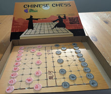 Load image into Gallery viewer, Open Chinese Chess set showing the box and the pieces setup on the board.