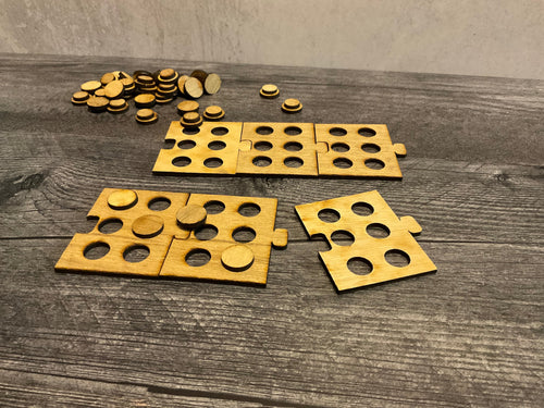 A shot showing 6 braille puzzle pieces. Each piece has 6 cut out slots for little pegs to sit in.