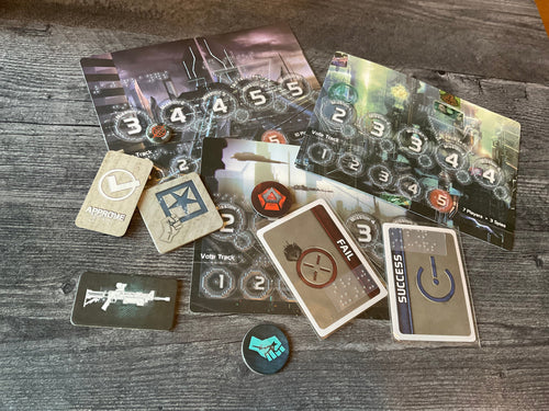 A bunch of the tokens and cards from the game laid out. all of the tokens and cards have transparent braille on them.
