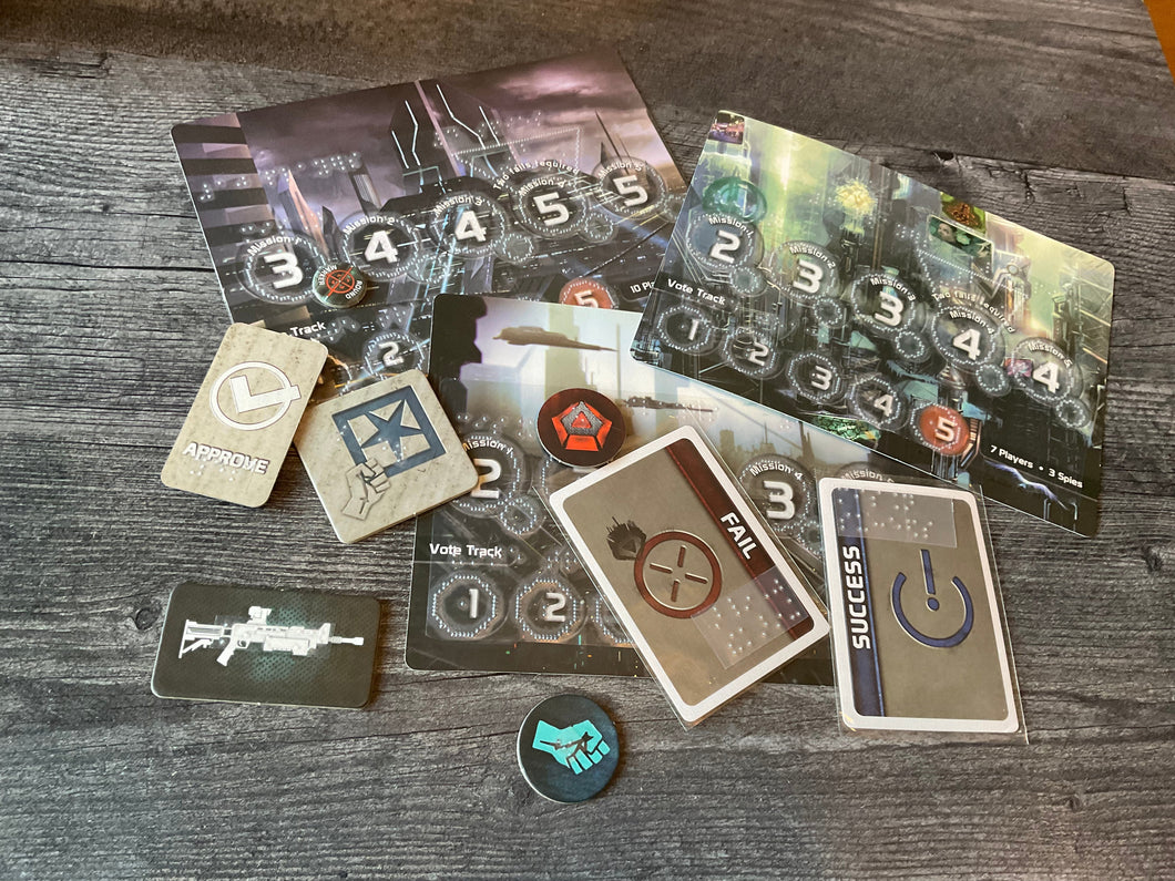 A bunch of the tokens and cards from the game laid out. all of the tokens and cards have transparent braille on them.