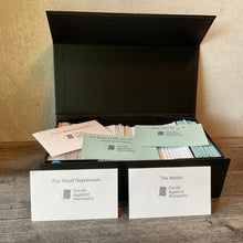 Load image into Gallery viewer, The box open. 2 blue prompt cards can be seen and 2 response cards. All cards are interpoint braille with large print on them. 
