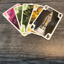 Load image into Gallery viewer, A close up on the cards with transparent braille stickers on them
