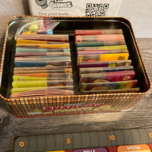 The tin showing all the brailled cards. Surprisingly enough, it can fit in the box even brailled