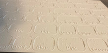 Load image into Gallery viewer, close up on the thermoformed game board. Both print and braille can be read
