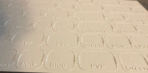 close up on the thermoformed game board. Both print and braille can be read