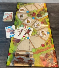 Load image into Gallery viewer, The My First Castle Panic board, laid out with monster tokens and cards on it. All have transparent braille on them
