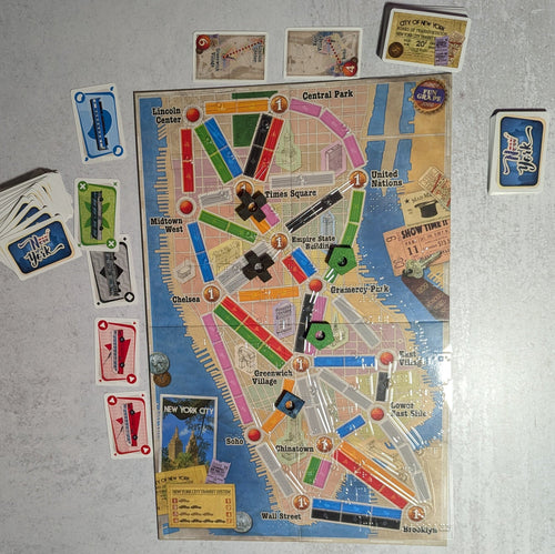 Shot of Ticket to Ride New York with clear overlay and Braille on all the game cards.