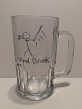 Load image into Gallery viewer, A clear glass beer mug with a handle, featuring a hand-drawn tactile black stick figure holding a mug and swinging a cane wildly. The text 'Blind Drunk' is below set against a plain light background in both print and braille.
