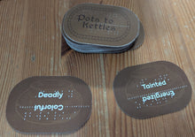 Load image into Gallery viewer, A stack of the kettle cards is shown. Each card has two words on them in both print and braille. This allows the judge to make a choice of which to use. They can be rotated so that the chosen side is face up.
